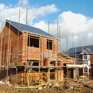 scaffold surrounds house being built.construction and building lightbox