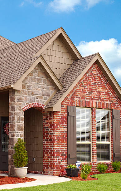 home entryway with sidewalk leading to stone archway